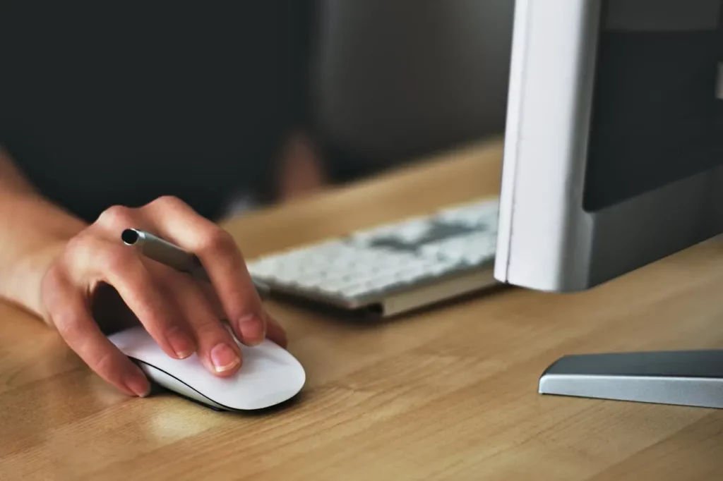 A focused real estate agent prioritizing tasks at their desk.