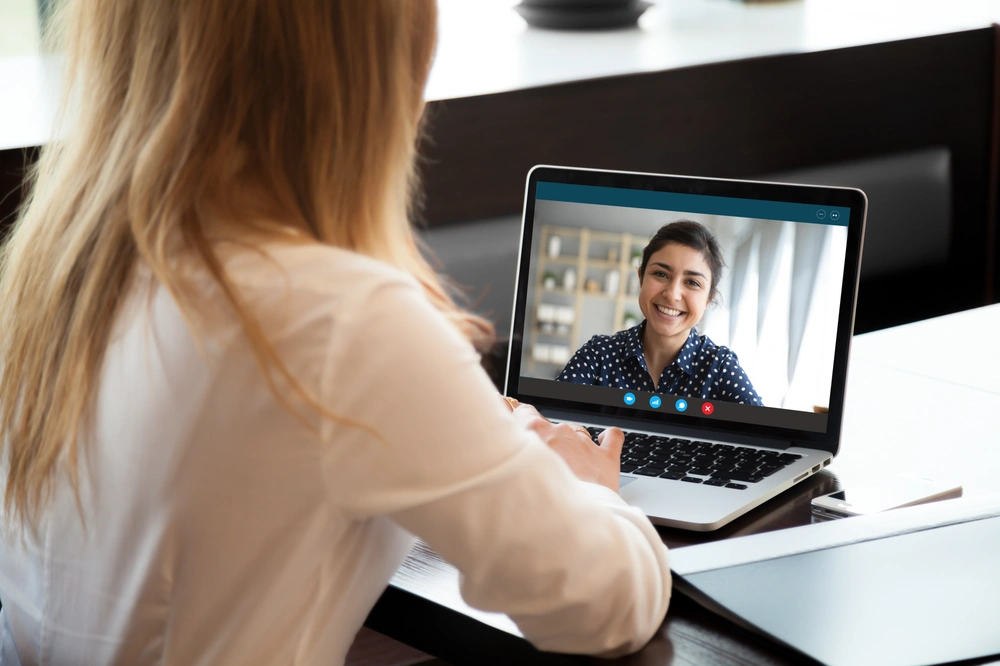 Realtor using video conferencing to communicate with clients.