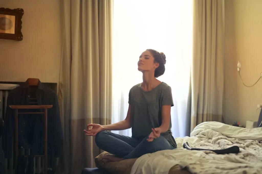 A person meditating with coffee in the morning