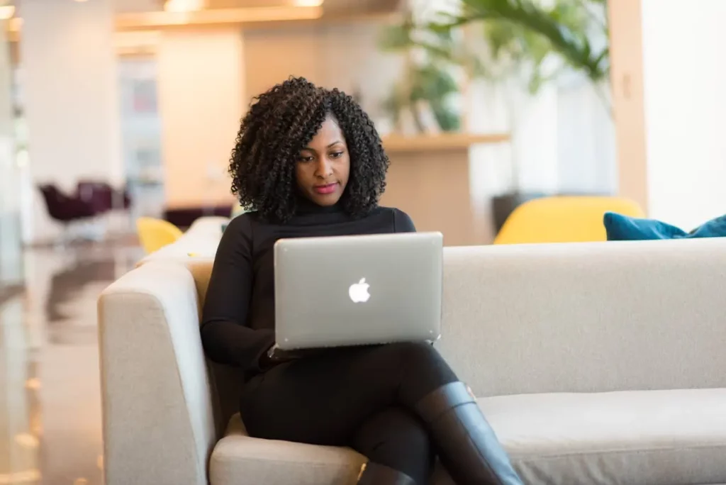 A realtor crafting a listing description on a laptop in a luxurious office.