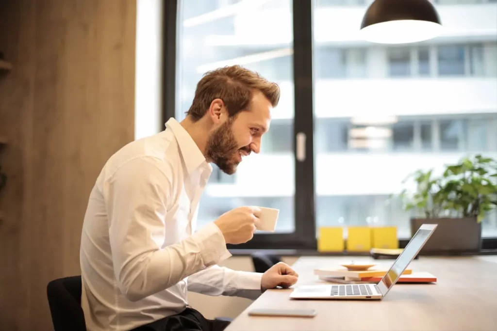 Image of an agent working on a laptop with real estate market reports and data charts 