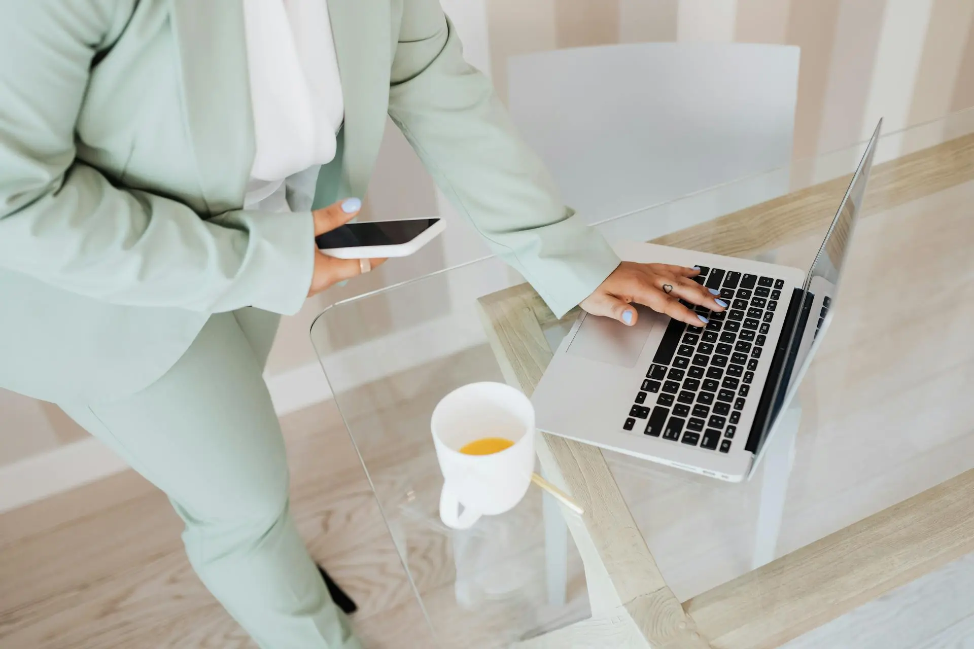 Person managing social media on a laptop and smartphone