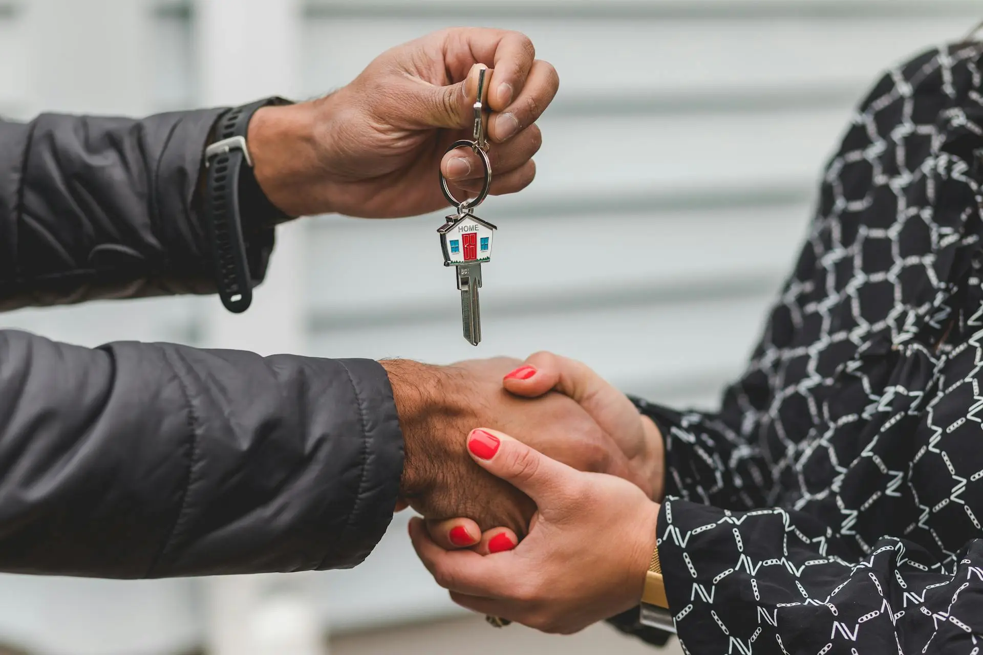 Real estate agent handing keys to a satisfied client