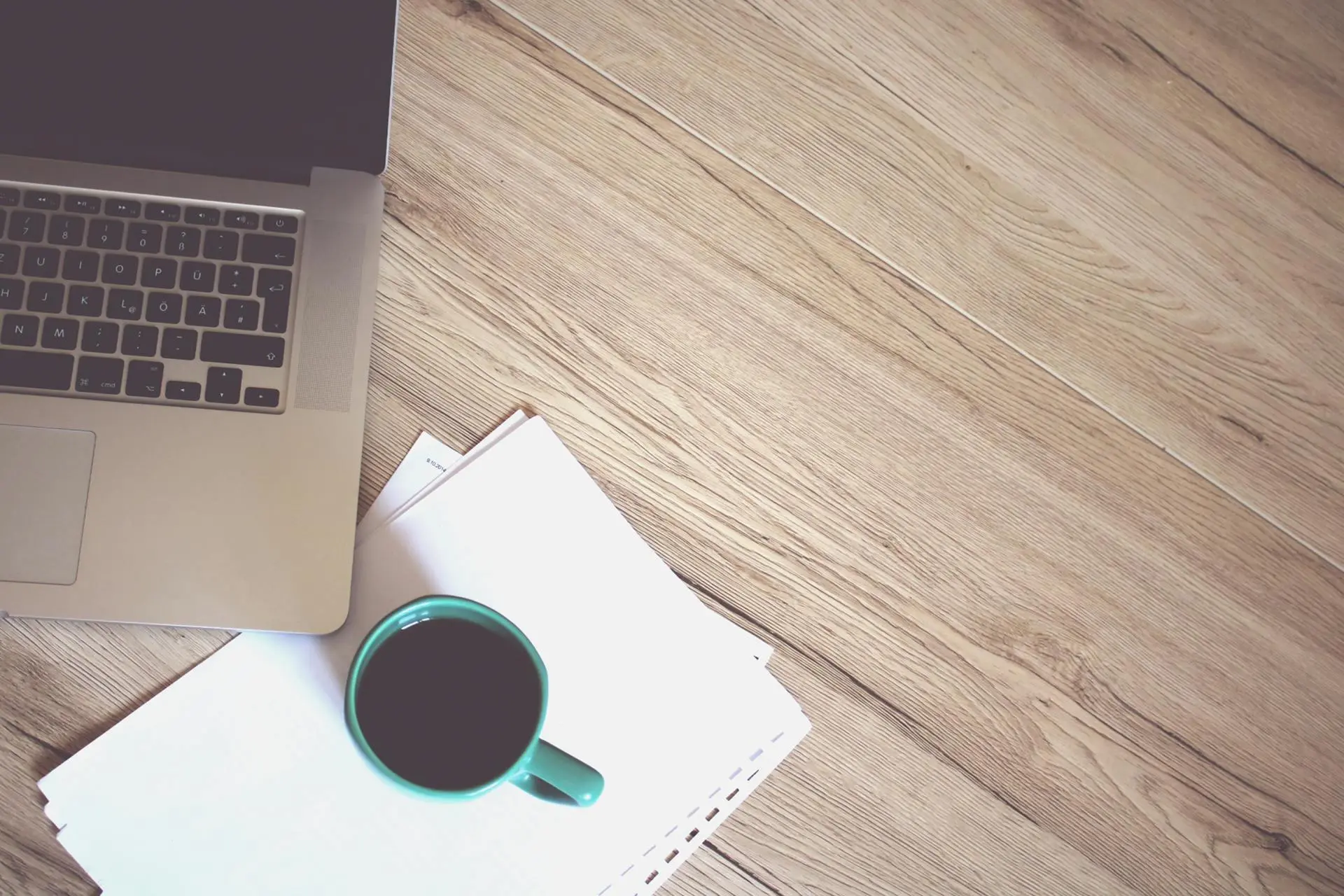 A person focusing on one task at a time with a laptop and notebook