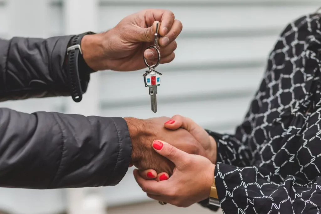 A real estate agent shaking hands with a satisfied client