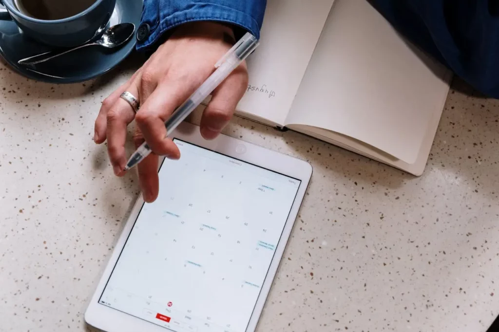 A realtor organizing their tasks on a digital planner