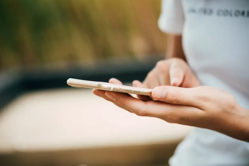 A realtor reviewing their social media engagement on a smartphone