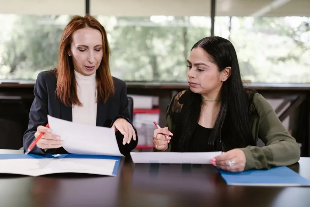 A realtor working with a transaction coordinator to finalize documents