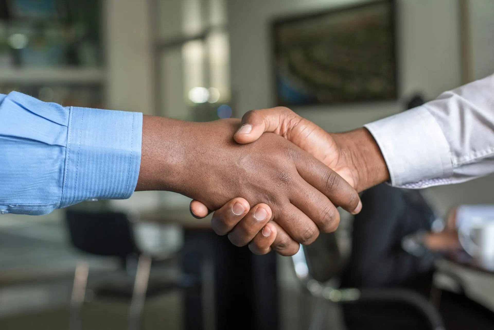 A Realtor shaking hands with a client, symbolizing a strong referral relationship