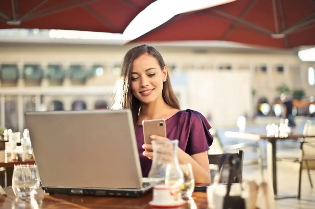 A Realtor smiling during a client follow-up call