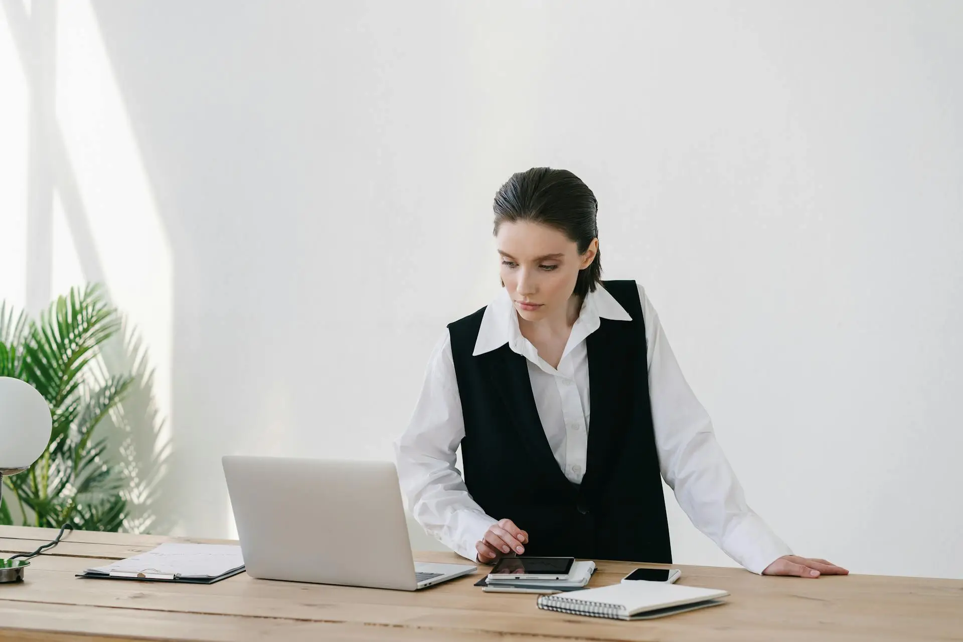 A Realtor using a tablet and smartphone to manage their business