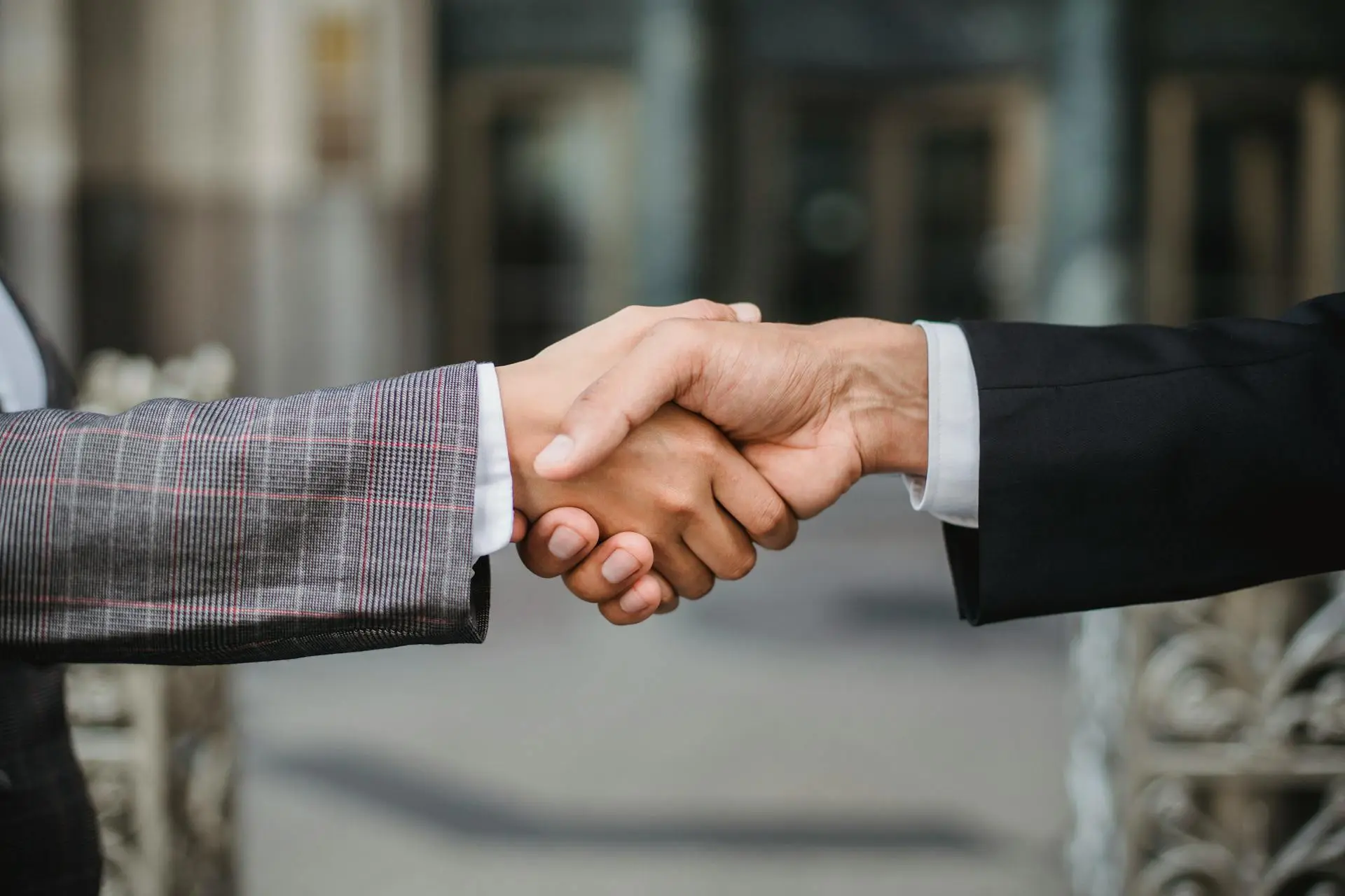 A happy Realtor shaking hands with a satisfied client