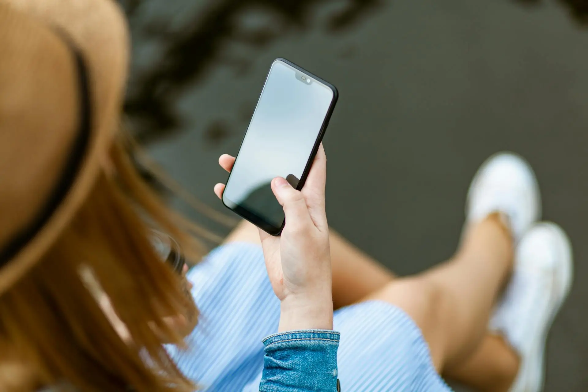 A Realtor holding a smartphone with Instagram Stories displayed on the screen.