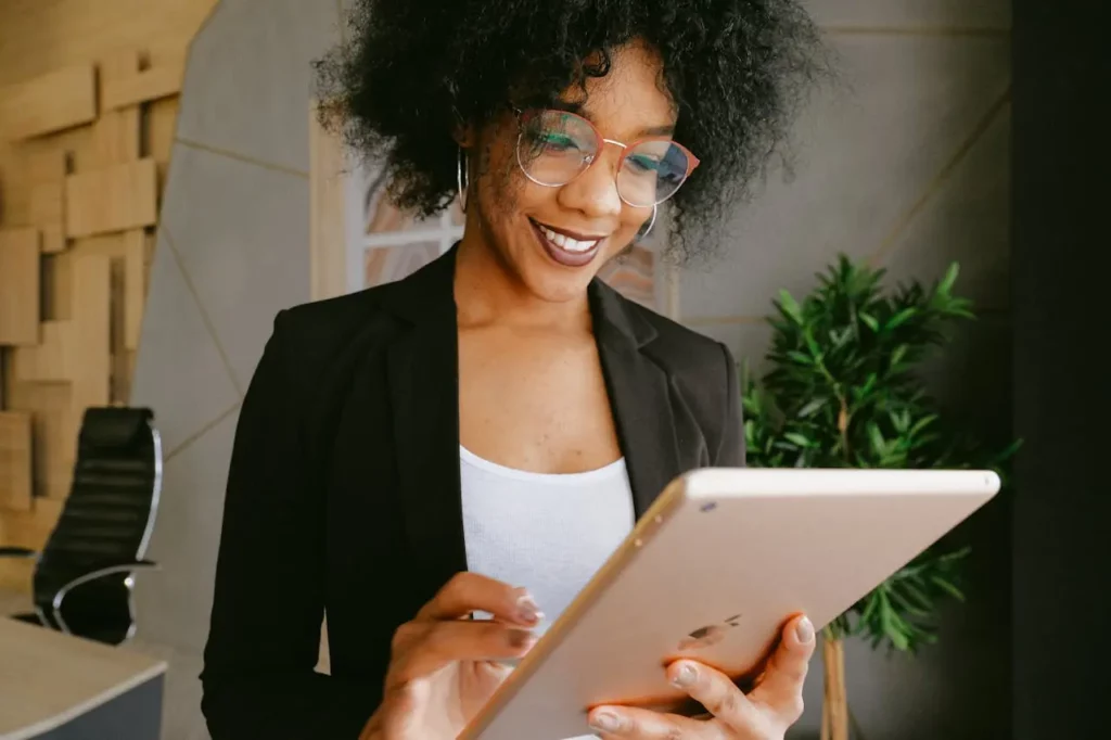 A Realtor using a CRM tool on a tablet to manage client interactions.