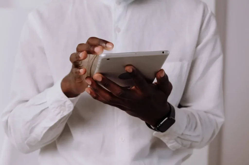 A Realtor using a CRM tool on their tablet to manage client follow-ups.