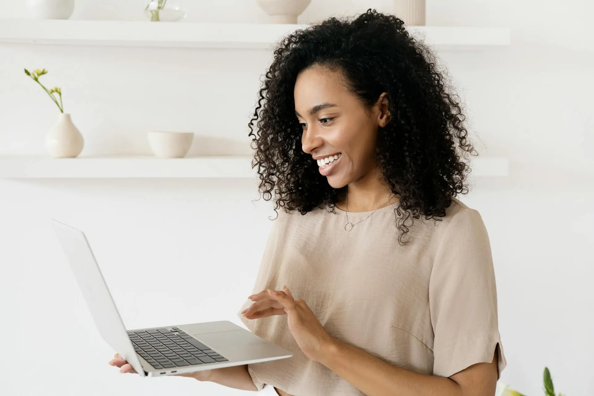 A Realtor working efficiently on a laptop with real estate software open.