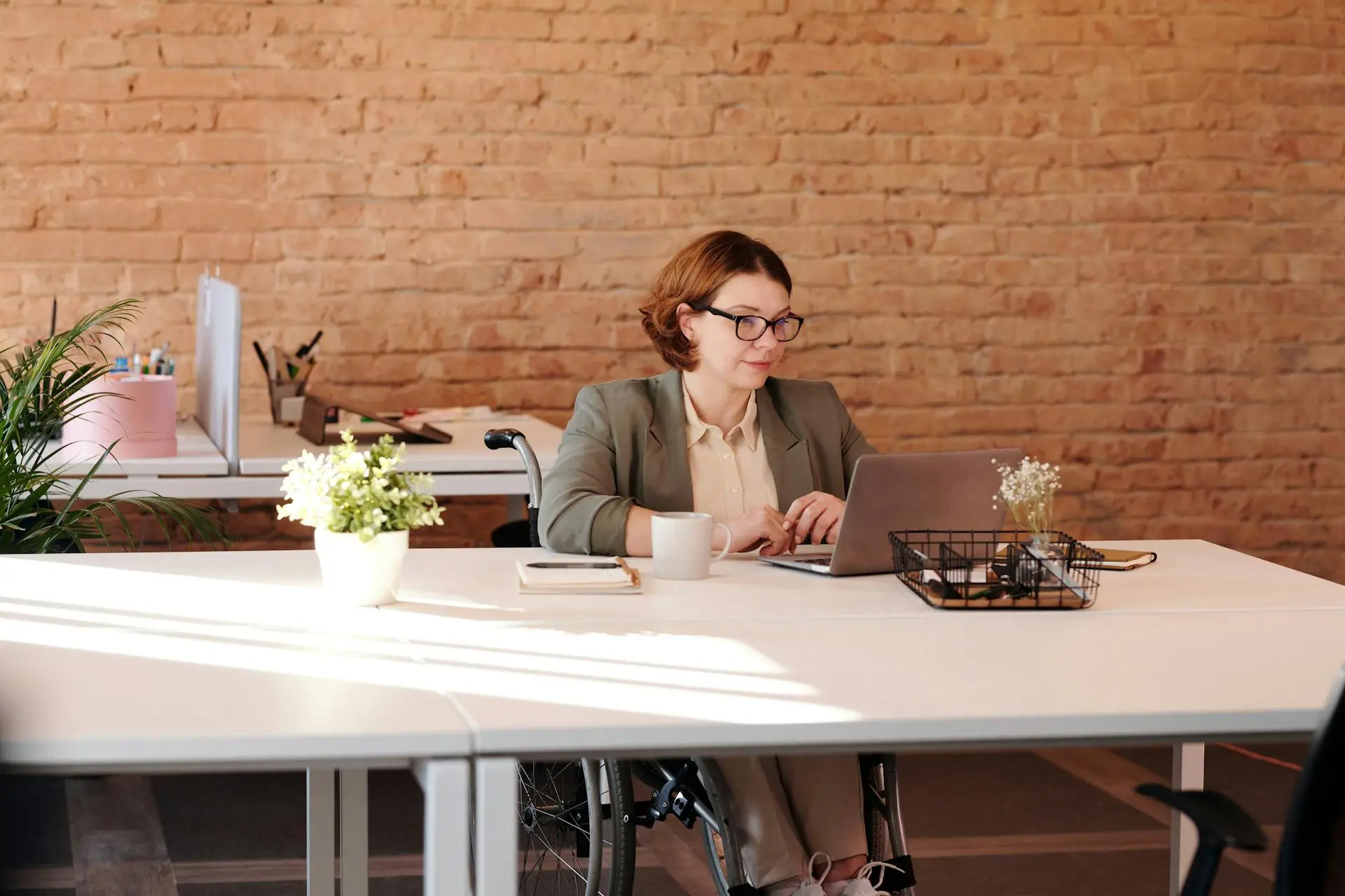 A focused Realtor working at a clean desk with a laptop and phone.