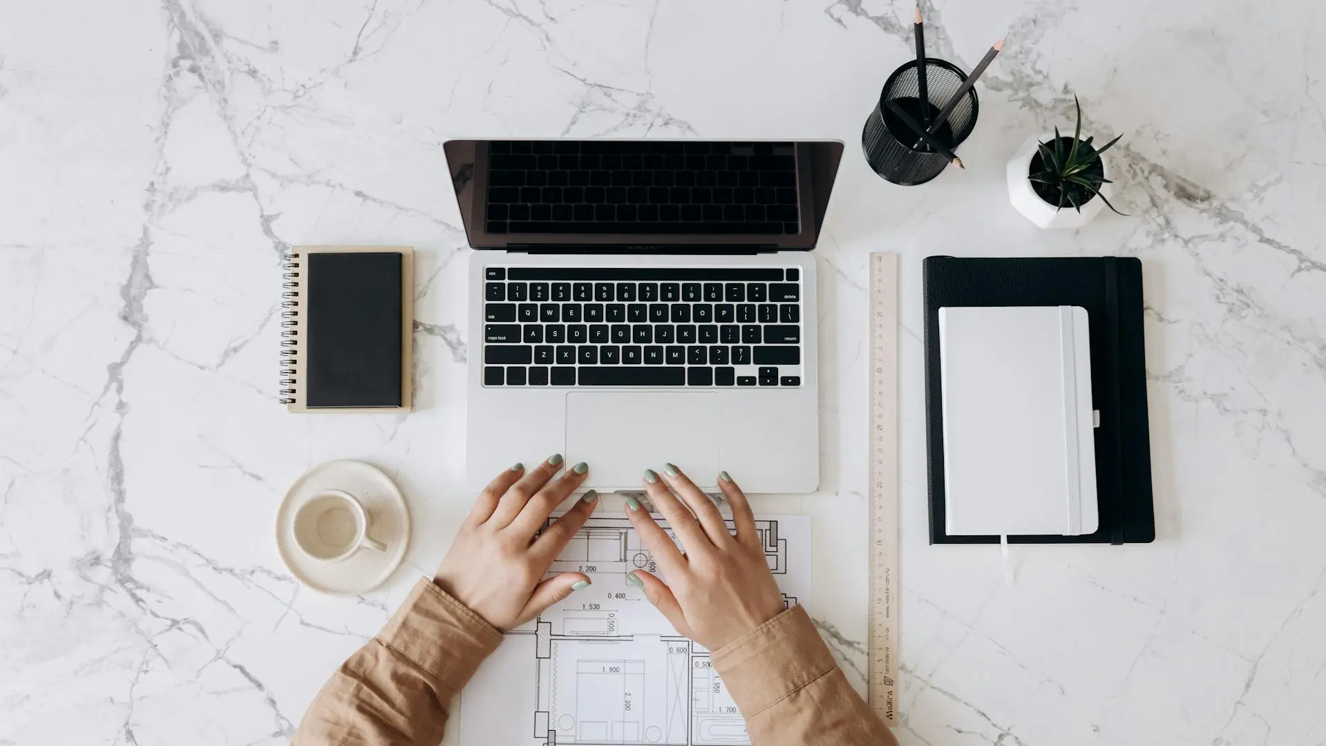 A successful Realtor reviewing their schedule on a laptop with a cup of coffee.