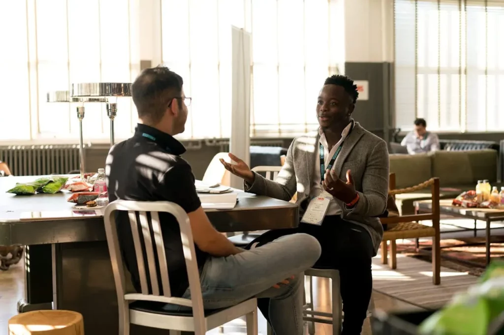 An image of a Realtor in a meeting with a marketing expert, reviewing branding materials.